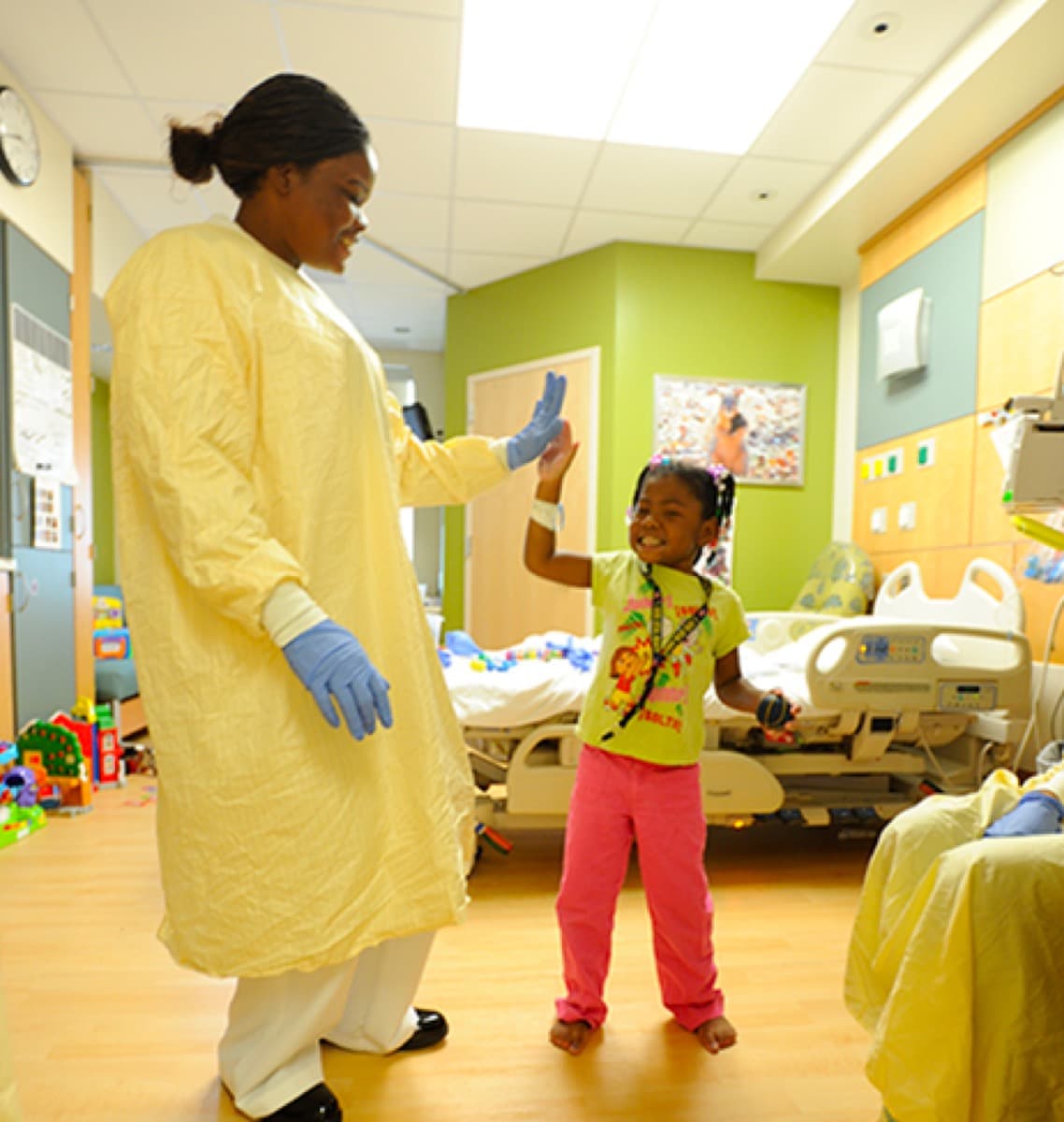 Nurse and young patient in a paediatric hospital room