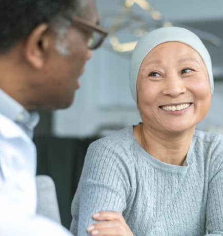 Smiling patient talking with her doctor